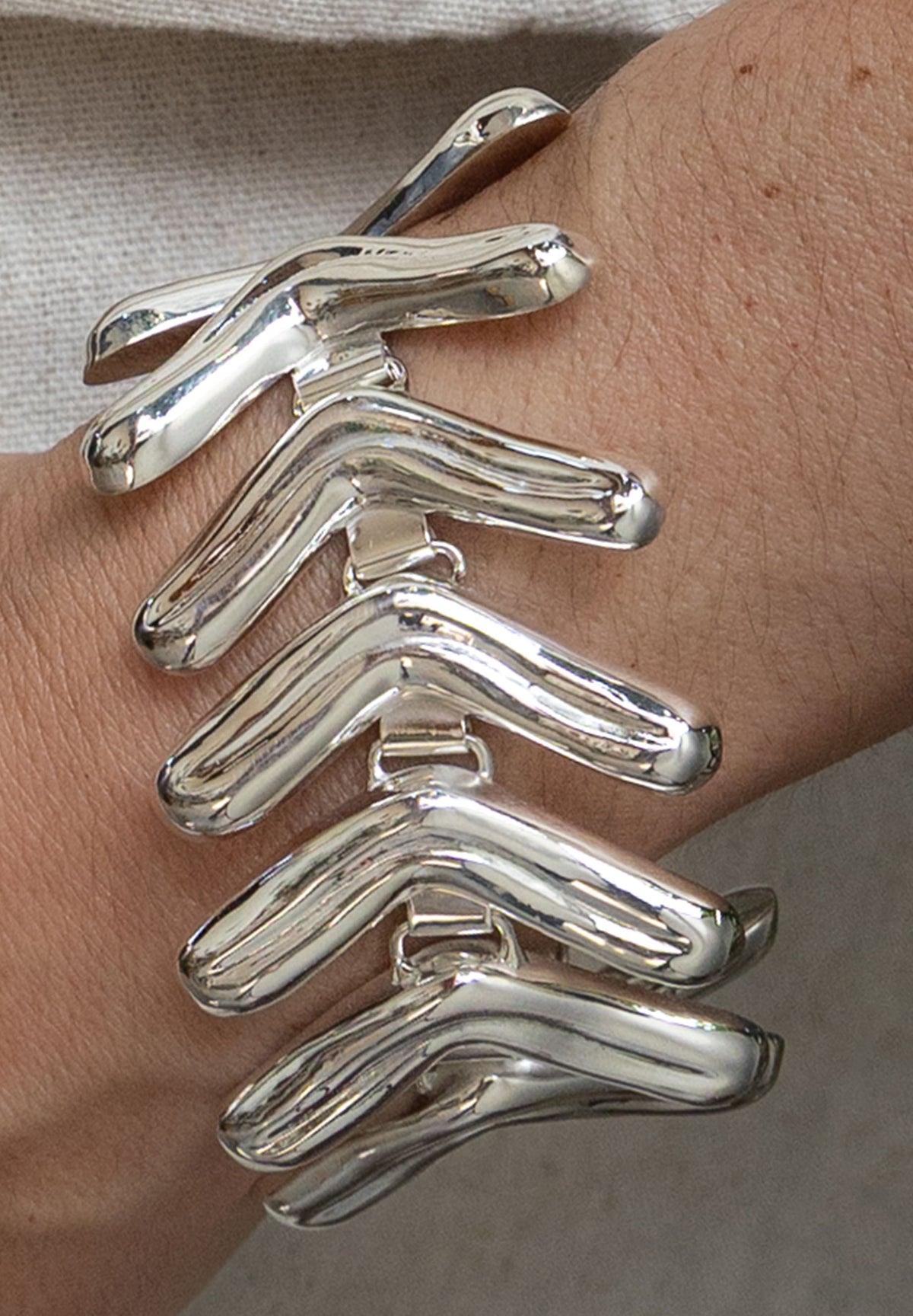 Lengua Bracelet in sterling silver, on model — handmade in Taxco, Mexico