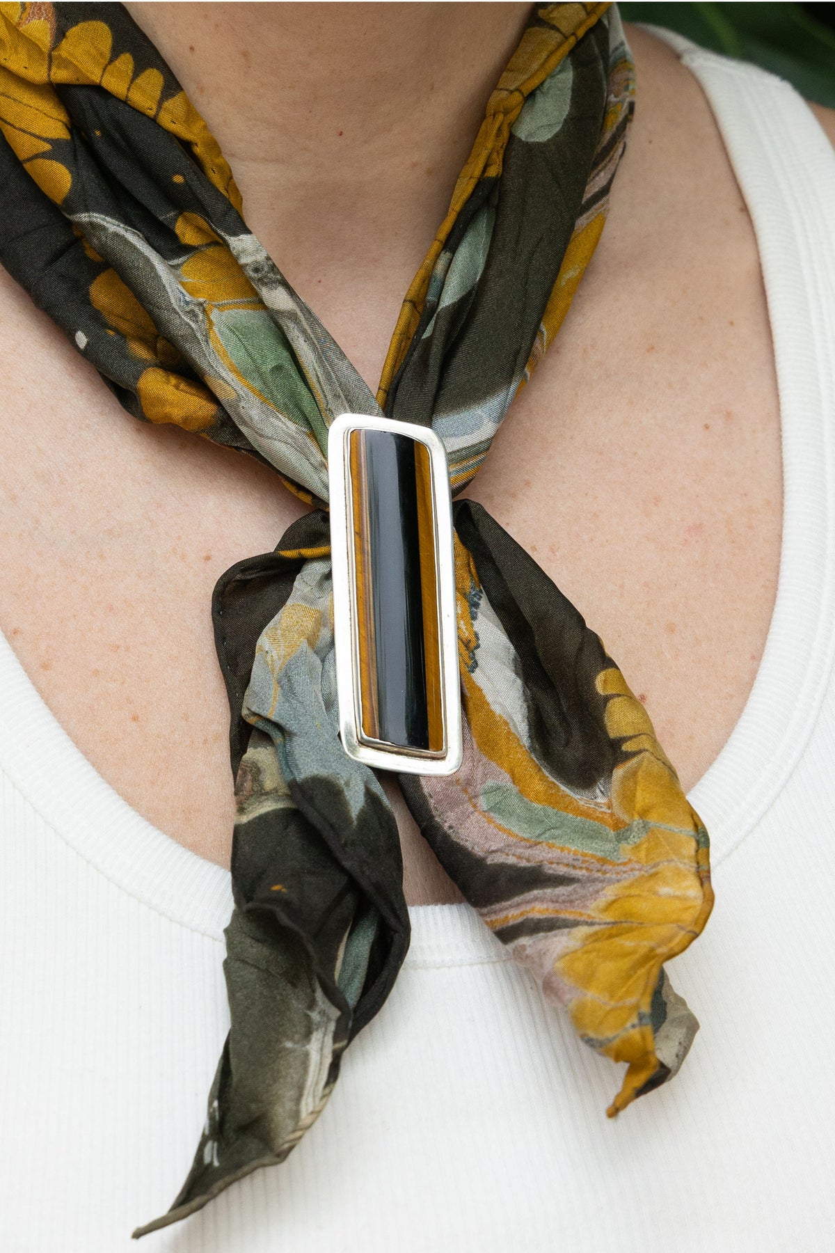 Tiger Eye & Obsidian Scarf Slide in sterling silver, on model — handmade in Taxco, Mexico