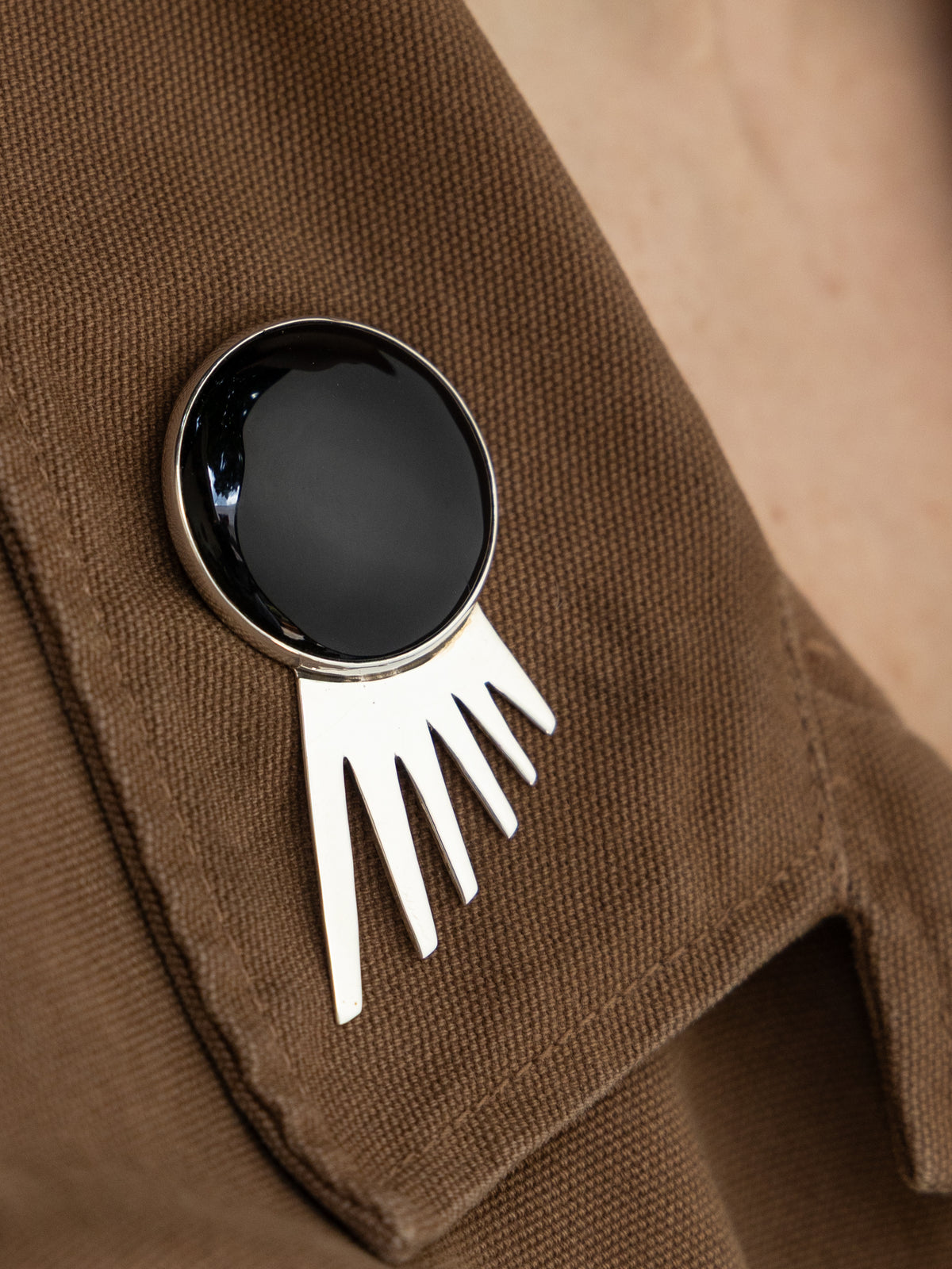 Sol Spur Pin Grande in sterling silver with black onyx, worn on the model — handmade in Taxco, Mexico #Gemstone Type_Onyx