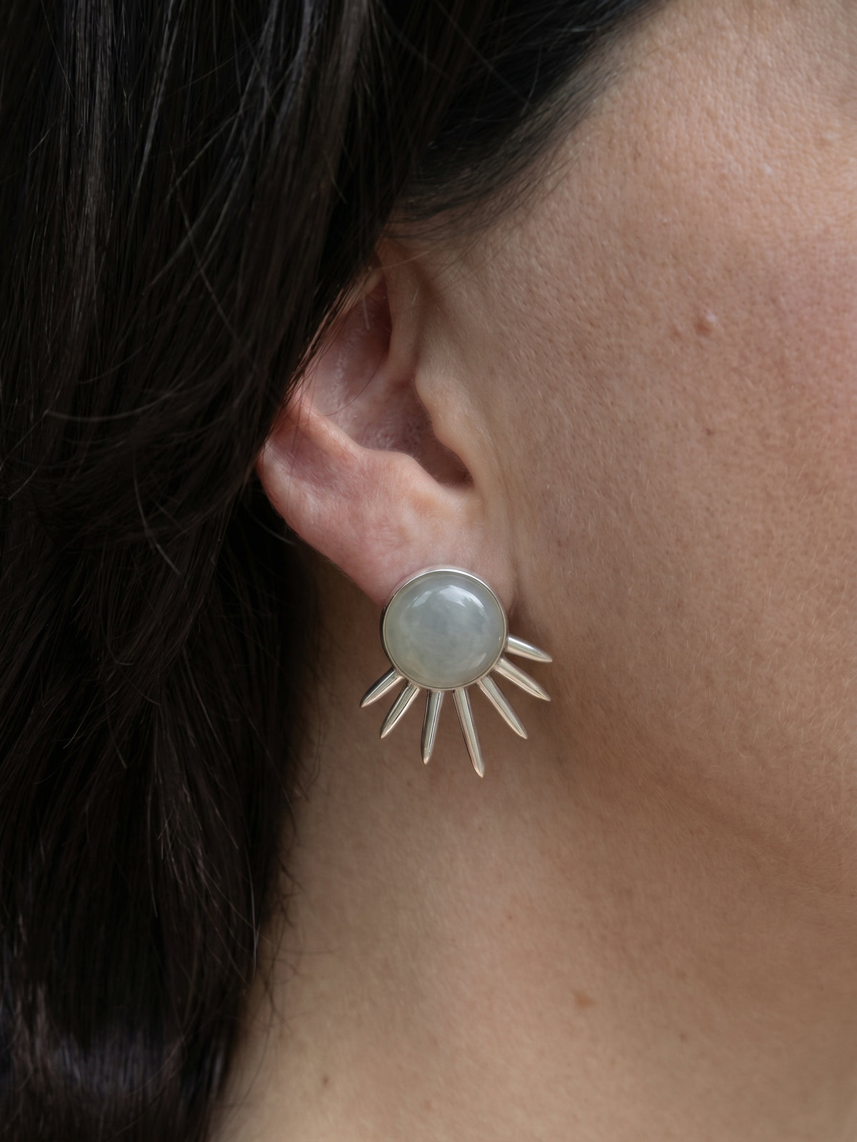 Sol Earrings in sterling silver with jade, worn on the ear — handmade in Taxco, Mexico #Gemstone Type_Jade