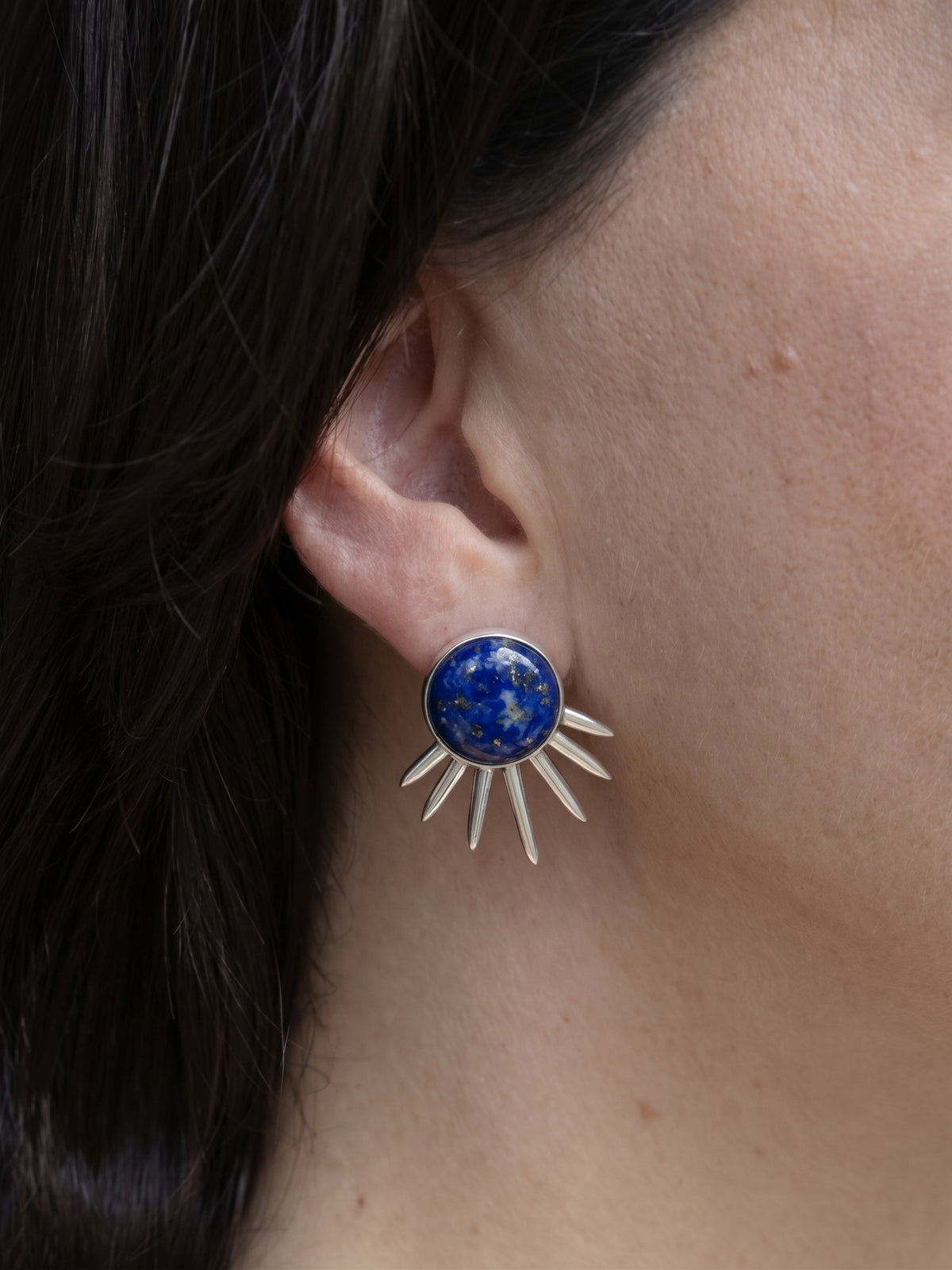 Sol Earrings in sterling silver with lapis lazuli, worn on the ear — handmade in Taxco, Mexico #Gemstone Type_Lapis lazuli