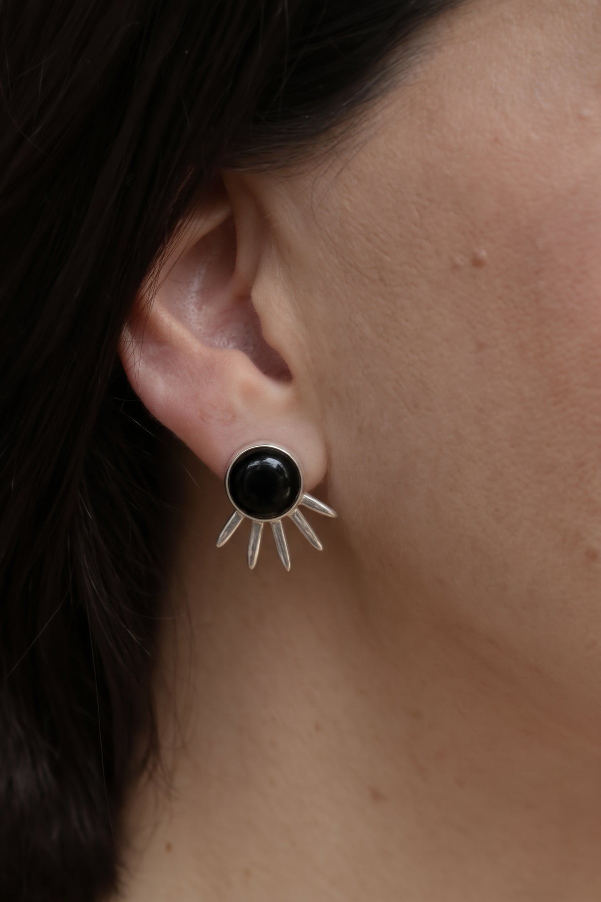 Sol Pequeño Earrings in sterling silver with black onyx, worn on the ear — handmade in Taxco, Mexico #Gemstone Type_Onyx