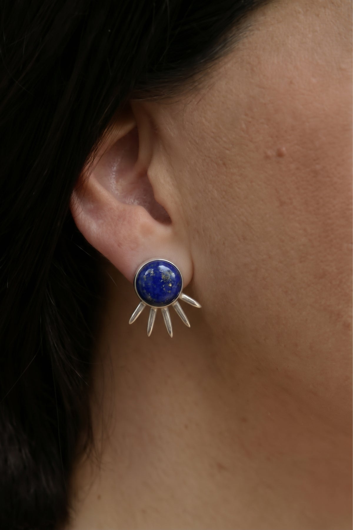 Sol Pequeño Earrings in sterling silver with lapis lazuli, worn on the ear — handmade in Taxco, Mexico #Gemstone Type_Lapis Lazuli