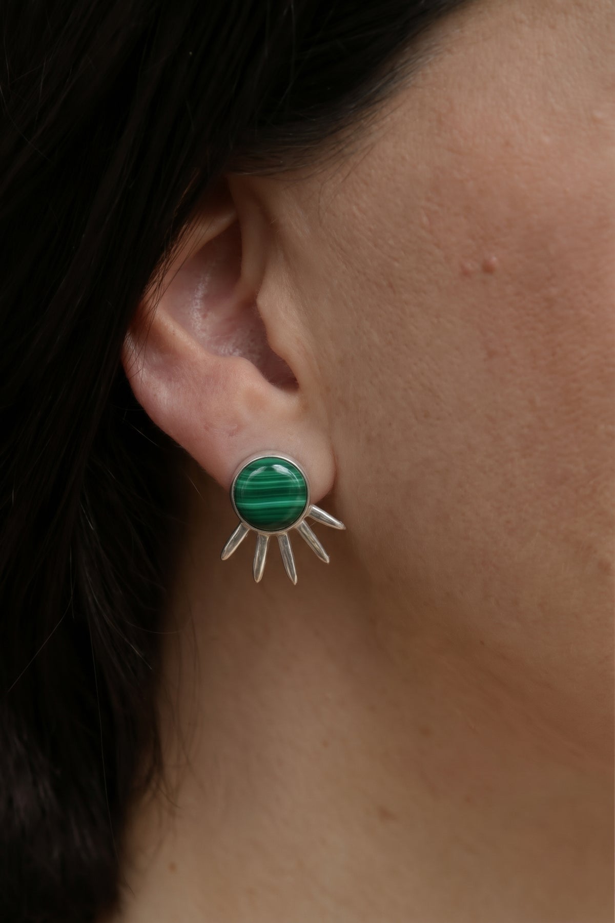 Sol Pequeño Earrings in sterling silver with malachite, worn on the ear — handmade in Taxco, Mexico #Gemstone Type_Malachite