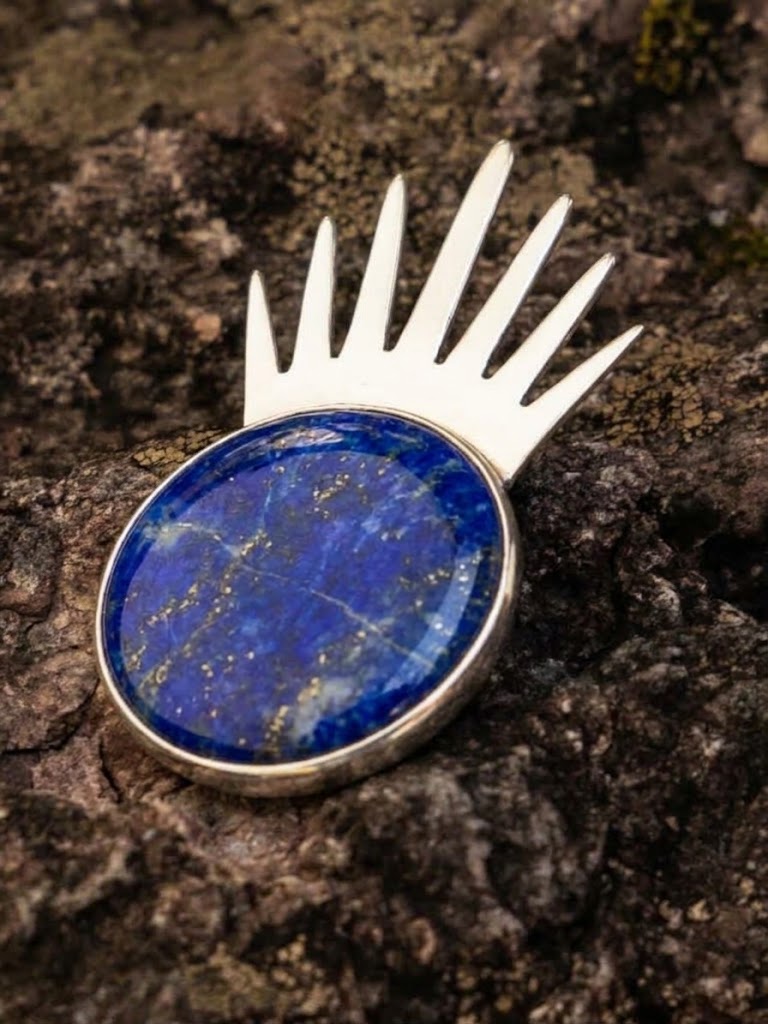 Sol Pin Grande in sterling silver with lapis lazuli, worn on the model — handmade in Taxco, Mexico #Gemstone Type_Lapis Lazuli