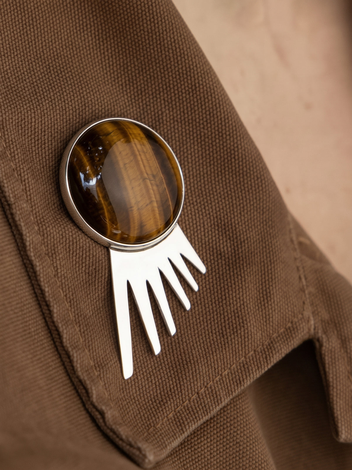 Sol Spur Pin Grande in sterling silver with tiger's eye, worn on the model — handmade in Taxco, Mexico #Gemstone Type_Tiger Eye